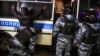 RUSSIA - A riot police officer searches a detained man during a protest against a court ruling ordered Russian opposition leader Alexei Navalny jailed for nearly three years, in downtown Moscow early on February 3, 2021