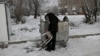 RUSSIA -- Bystrushkin, who is visually impaired and homeless, looks through a rubbish bin in Omsk, Russia, November 28, 2019. REUTERS/Alexey Malgavko 