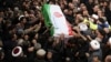 IRAN -- A handout picture provided by the office of Iran's Supreme Leader Ayatollah Ali Khamenei shows mourners carrying the casket of slain top Iranian military commander Qasem Soleimani, after he was killed in a US strike in Baghdad last week, in the ca