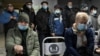 RUSSIA - People wearing protective face masks, used as a preventive measure against the spread of the coronavirus disease (COVID-19), wait in a queue near a reception desk at a local clinic in Omsk, Russia November 9, 2020