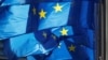 BELGIUM -- European Union flags are seen outside the EU Commission headquarters in Brussels, prior to a meeting between Britain's Secretary of State for Exiting the EU Dominic Raab and EU's chief Brexit negotiator Michel Barnier, Belgium October 14, 2018.