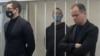 RUSSIA -- Ivan Safronov (center), a former journalist and an aide to the head of Russia's space agency Roscosmos who remains in custody on state treason charges, stands inside a defendants' cage as he attends a court hearing in Moscow, November, 2020