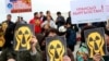 KYRGYZSTAN -- Supporters of the Green Party of Kyrgyzstan hold placards during a rally in the central square in Bishkek against the development of Uranium ore and the dumping of waste on Issyk-Kul Lake in Bishkek, April 26, 2019